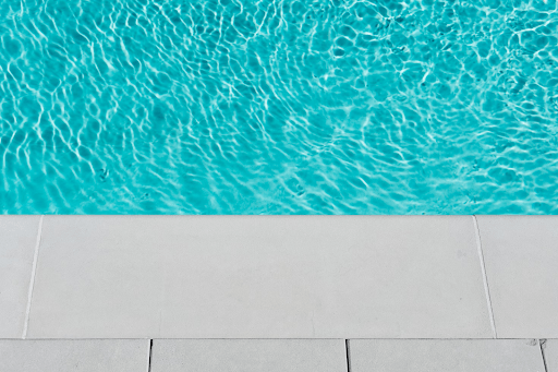 Top view of a clear blue swimming pool with tiled edge at a holiday rental property in Victoria